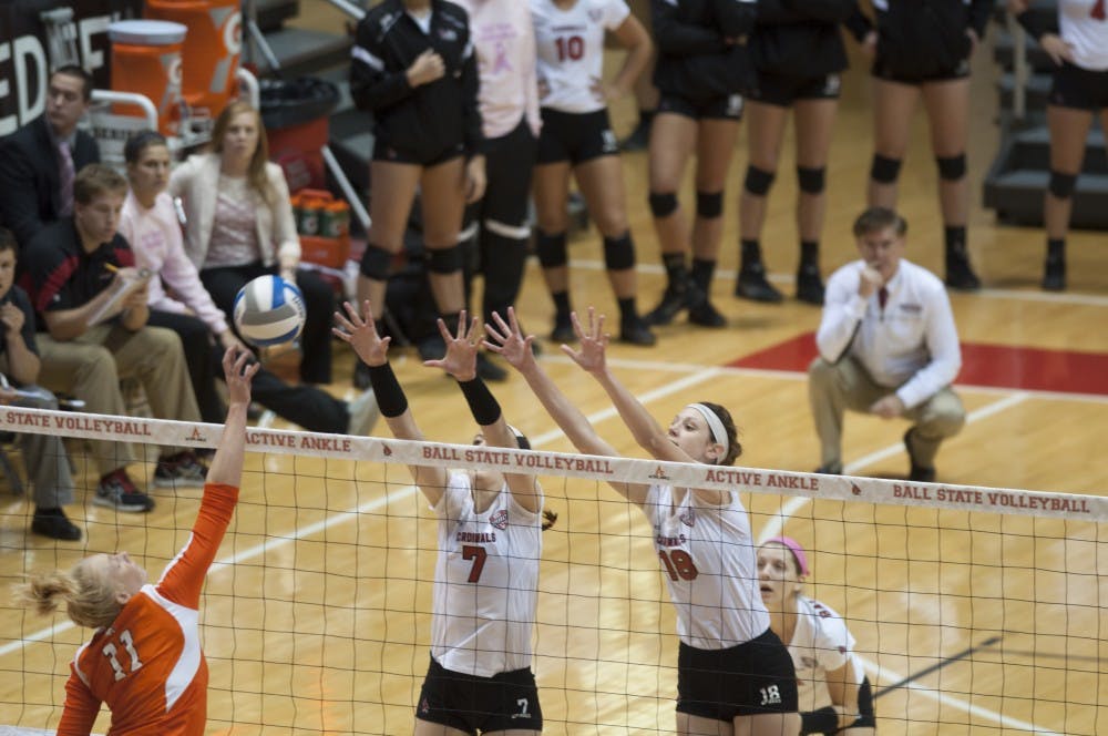 Senior opposite hitter Lauren Grant and sophomore middle hitter Hayley Benson jump up to block a hit against Bowling Green State University on Oct. 25 at Worthen Arena. Ball State lost the match 3-1. DN PHOTO MATT McKINNEY