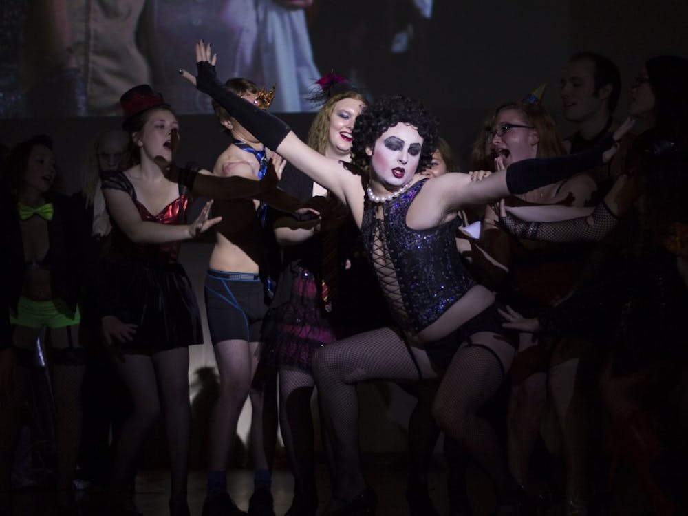 Cast members of "The Rocky Horror Picture Show" surround Dr. Frank N. Furter, played by Zachary Ryan Allen, during the performance on Oct. 31. DN PHOTO EMMA ROGERS