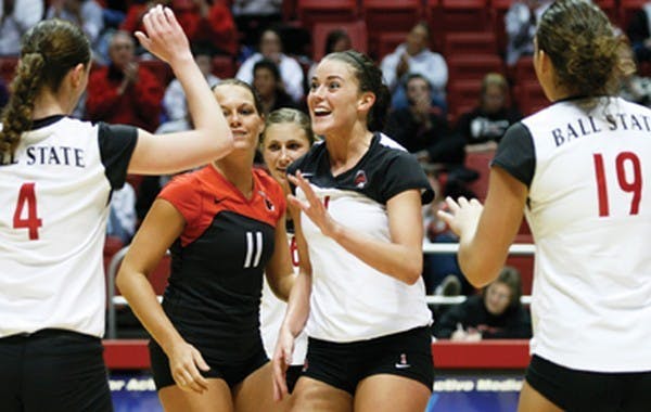 Brittany May celebrates a kill with her teammates during the match against Buffalo in Worthen Arena Tuesday to open MAC Tournament play. May had 19 kills against Buffalo and leading the Cards' 3-2 victory over the Bulls with an attack percentage of .425. DN PHOTO/WILL VRAGOVIC