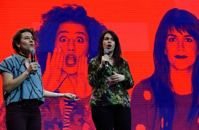 Ilana Glazer, left, and Abbi Jacobson of the Comedy Central show "Broad City"at the news conference announcing Spotify’s new services. The channel, and others, will provide short video clips. Photo by Don Emmert/Agence France-Presse — Getty Images