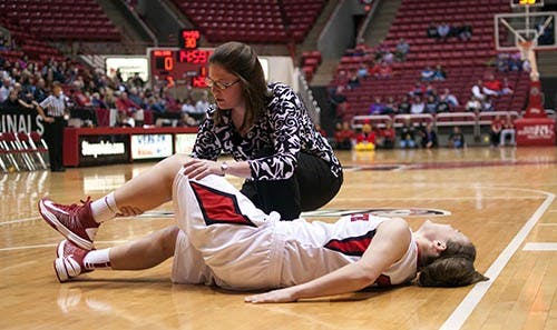 Freshman Taylor Miller cries out as a trainer attempts to move her leg after she suffered an injury in the first half. Miller didn’t return to the game. DN PHOTO BOBBY ELLIS