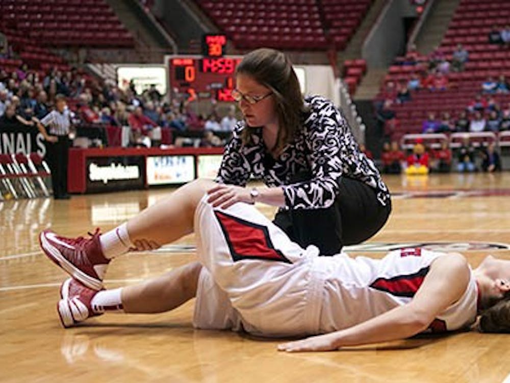 Freshman Taylor Miller cries out as a trainer attempts to move her leg after she suffered an injury in the first half. Miller didn’t return to the game. DN PHOTO BOBBY ELLIS