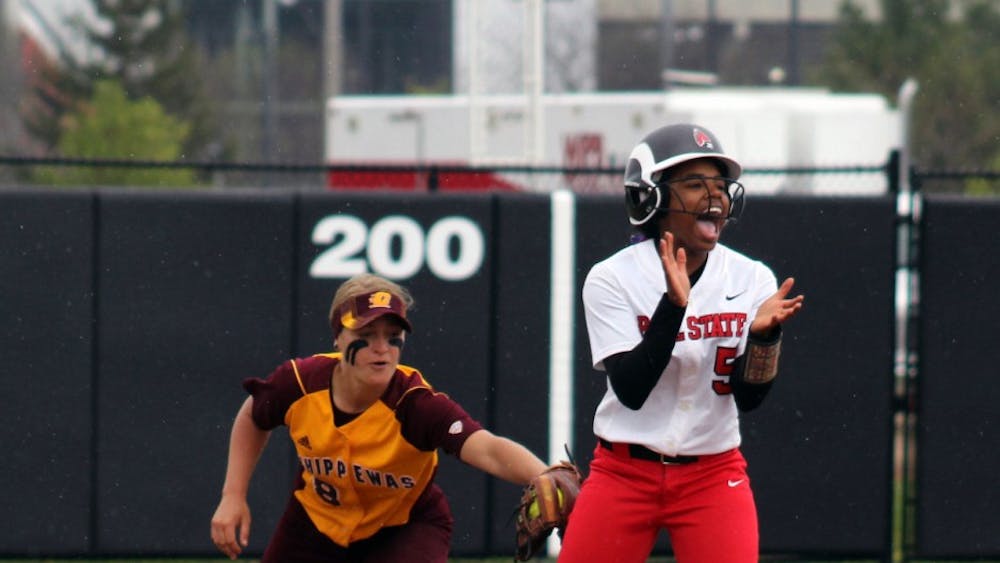 Freshman infielder Aeshia Miles attempts to rally her team as her opponent attempts to tag her out in the game against Central Michigan on Friday, April 22, 2016 at the Varsity Softball Complex. DN PHOTO ALLYE CLAYTON