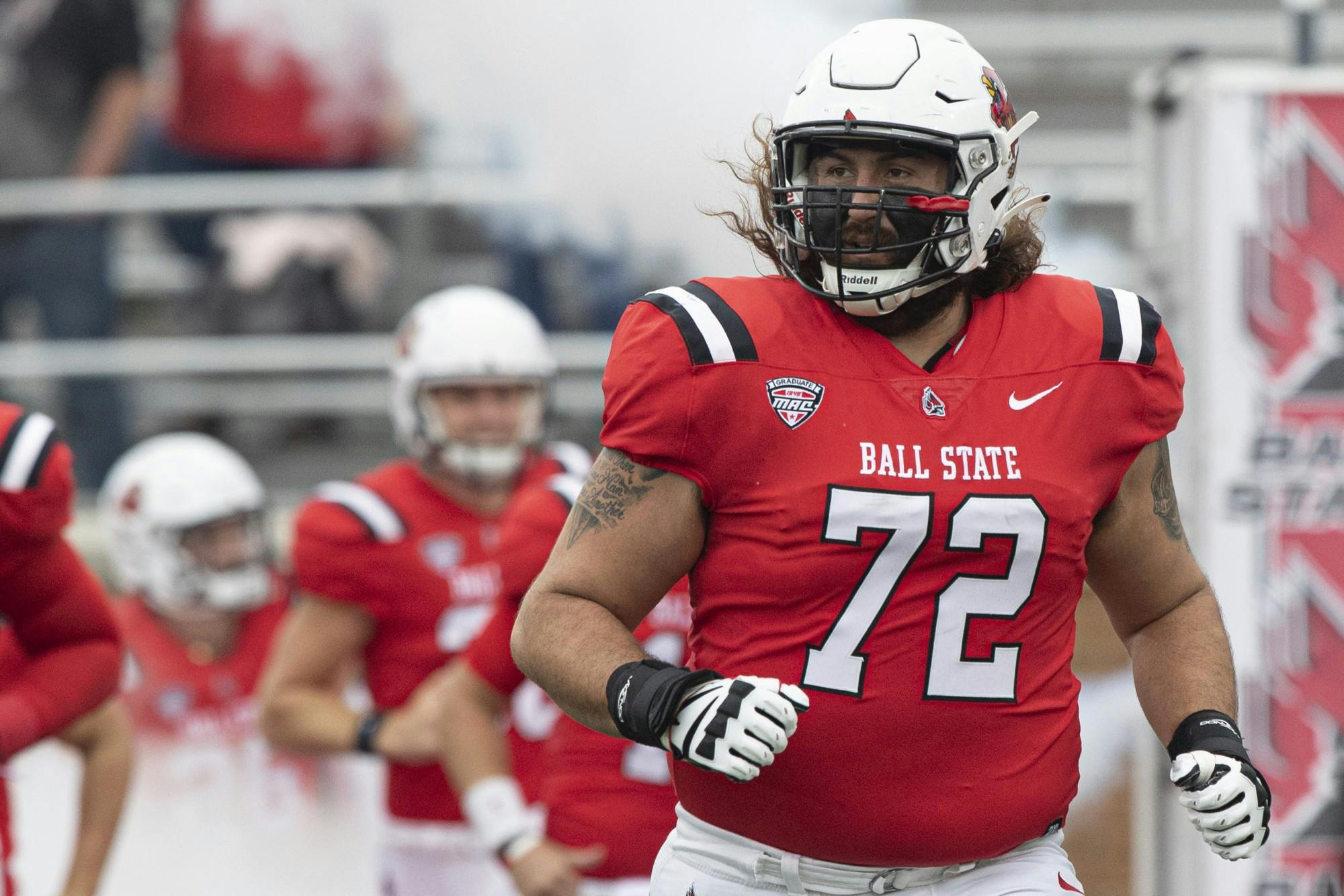 Cardinals redshirt fifth-year senior Anthony Todd runs out of the fog during team runout Oct. 2, 2021, at Scheumann Stadium. The Cardinals beat the Black Knights 28-16. Jacob Musselman, DN