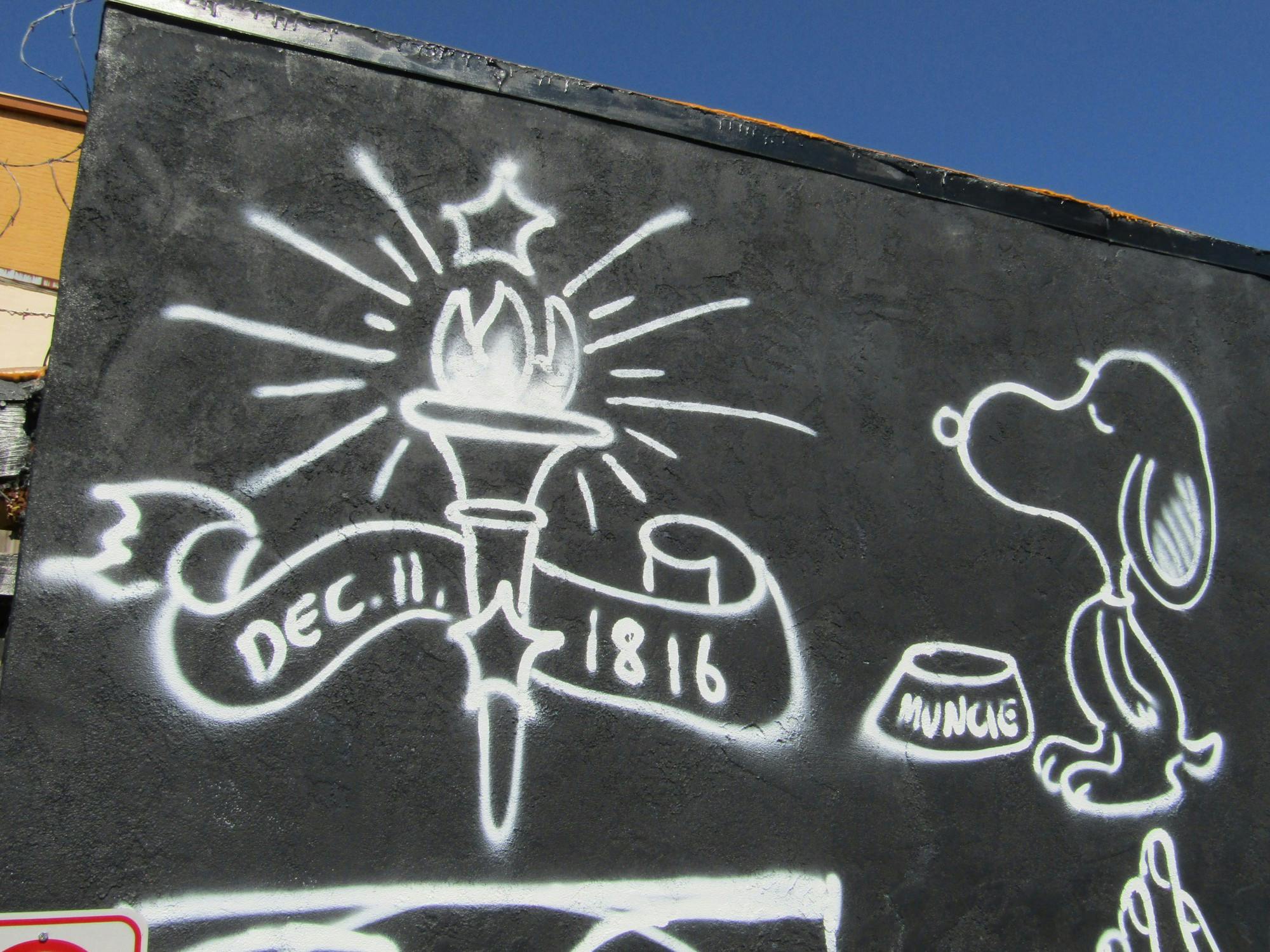 Art on the side of two buildings in downtown Muncie, Indiana, pictured the morning of July 19, 2022. This art not only showcases the artists' ability but promotes the local businesses inside the building the art is featured on. (Kyle Smedley/DN)