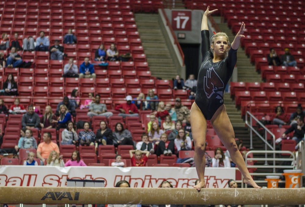 Sophomore Baylee Bell performs her routine on the beam during the meet against Eastern Michigan and Illinois State on Jan. 24 in Worthen Arena. DN PHOTO BREANNA DAUGHERTY