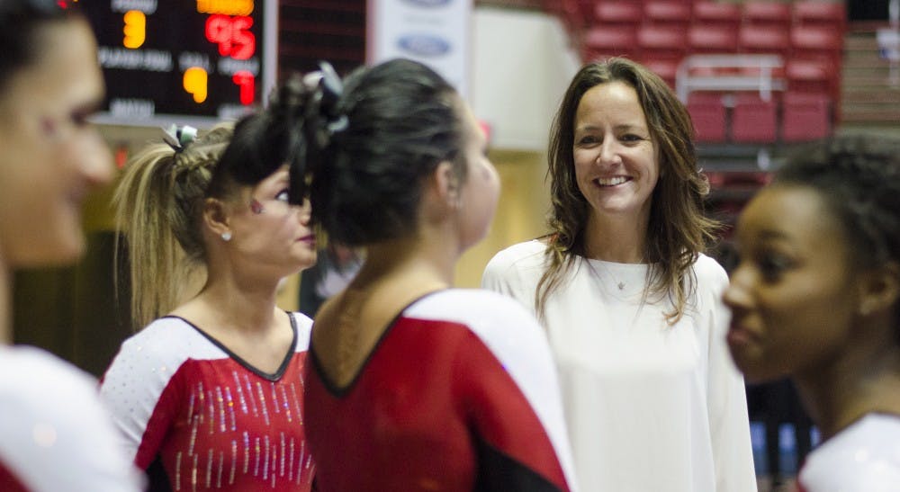 Head coach Joanna Saleem talks to some of the gymnasts in between events during the meet against Townson on Jan. 17 at Worthen Arena. DN PHOTO BREANNA DAUGHERTY