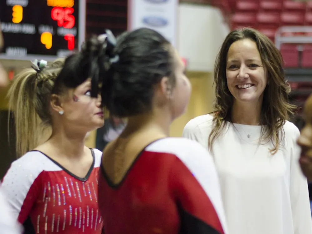 Head coach Joanna Saleem talks to some of the gymnasts in between events during the meet against Townson on Jan. 17 at Worthen Arena. DN PHOTO BREANNA DAUGHERTY