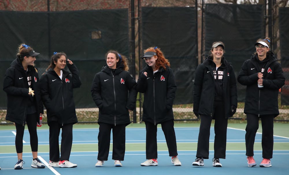 The Cardinals laugh after cheering on their teammates March 26, 2021, in the Cardinal Creek Tennis Center. The Cardinals won 4-3 against the Falcons. Rylan Capper, DN 