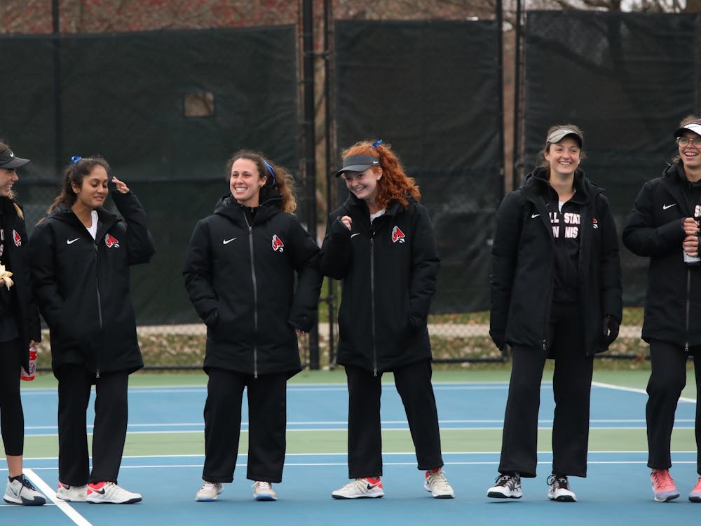 The Cardinals laugh after cheering on their teammates March 26, 2021, in the Cardinal Creek Tennis Center. The Cardinals won 4-3 against the Falcons. Rylan Capper, DN 