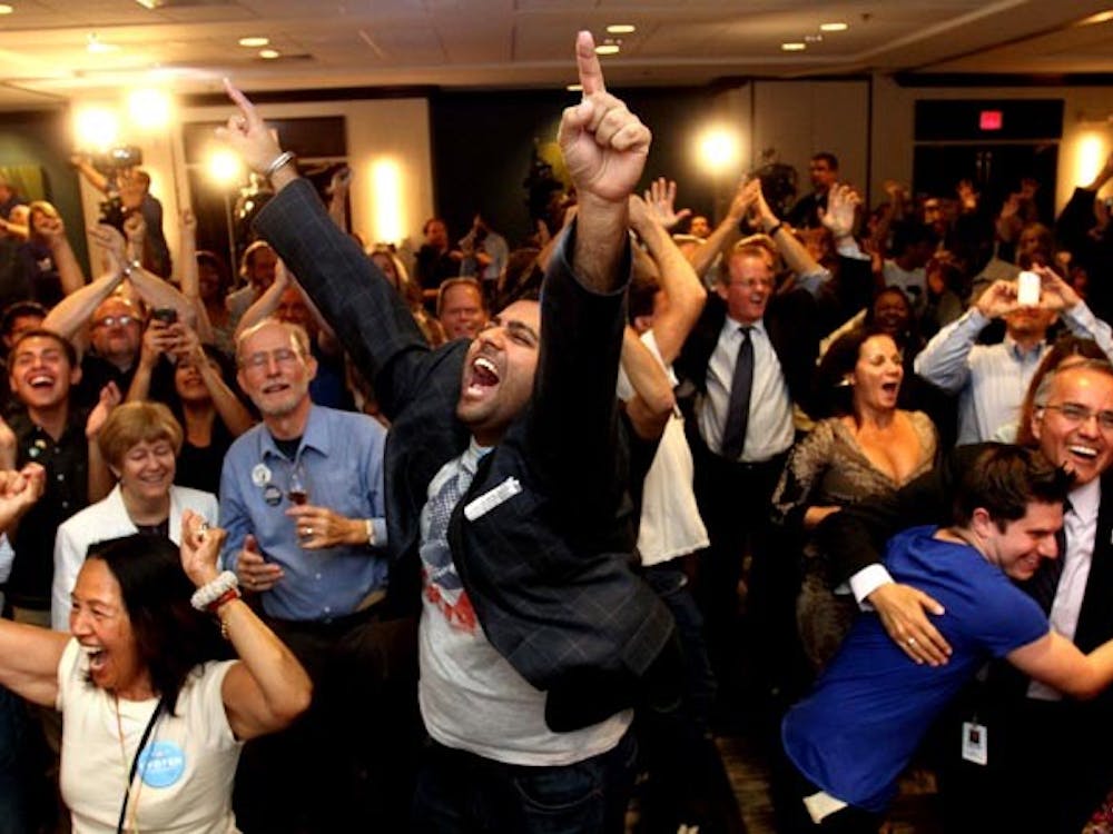 Democratic supporters react as President Barack Obama is projected to defeat Mitt Romney to win re-election during campaign party in Orlando, Florida, on Tuesday, November 6, 2012. (Joe Burbank/Orlando Sentinel/MCT)