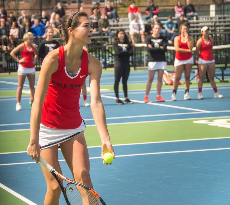 Sophomore Audrey Berger serves the ball during the match against Buffalo on April at the Cardinal Creeek Tennis Center. Berger and her doubles partner, sophomore Isabelle Dohanics, won their match 2-0. Teri Lightning Jr., DN