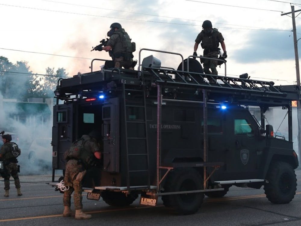The St. Louis County Police tactical officers fire tear gas on West Florissant Rd on Monday, August 11, 2014, in Ferguson, Mo.(Robert Cohen/St. Louis Post-Dispatch/MCT)