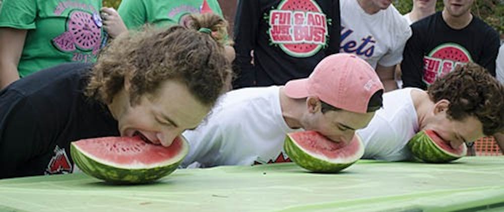 Junior construction management major David Schemerhorn, sophomore marketing major Jonah Katz and sophomore anthropology major Alex Selvey compete in the watermelon eating contest on Oct. 5. The contest was part of the 41st Annual Watermelon Bust on LaFollette Field. DN PHOTO BREANNA DAUGHERTY 