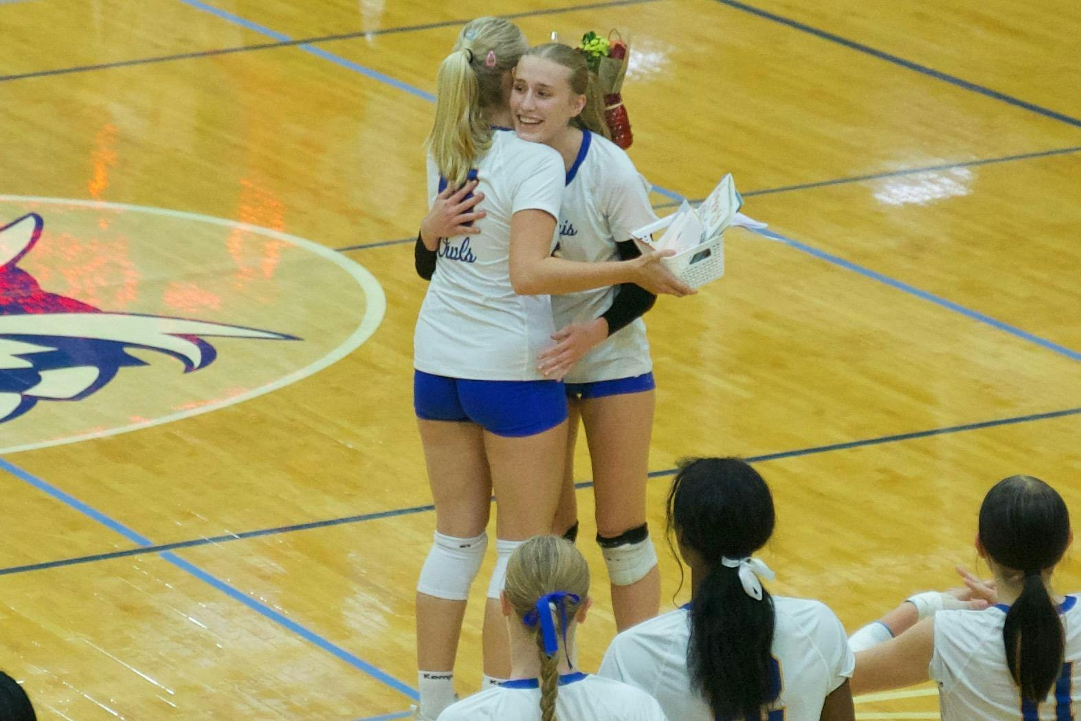 The Owls and junior setter/opposite hitter Addi Pierce (#3) recognize senior setter Klara Gelzer (#16) with a surprise presentation of flowers before the match. Burris went on to win in straight sets over Frankton, improving their overall record to 15–4. Photo by BRODRICK GOOD.
