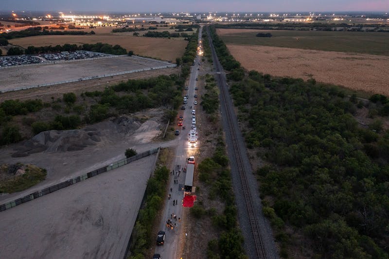 In this aerial view, members of law enforcement investigate a tractor trailer on June 27, 2022, in San Antonio, Texas. According to reports, at least 46 people, who are believed migrant workers from Mexico, were found dead in an abandoned tractor trailer. Over a dozen victims were found alive, suffering from heat stroke and taken to local hospitals. (Jordan Vonderhaar/Getty Images/TNS)
