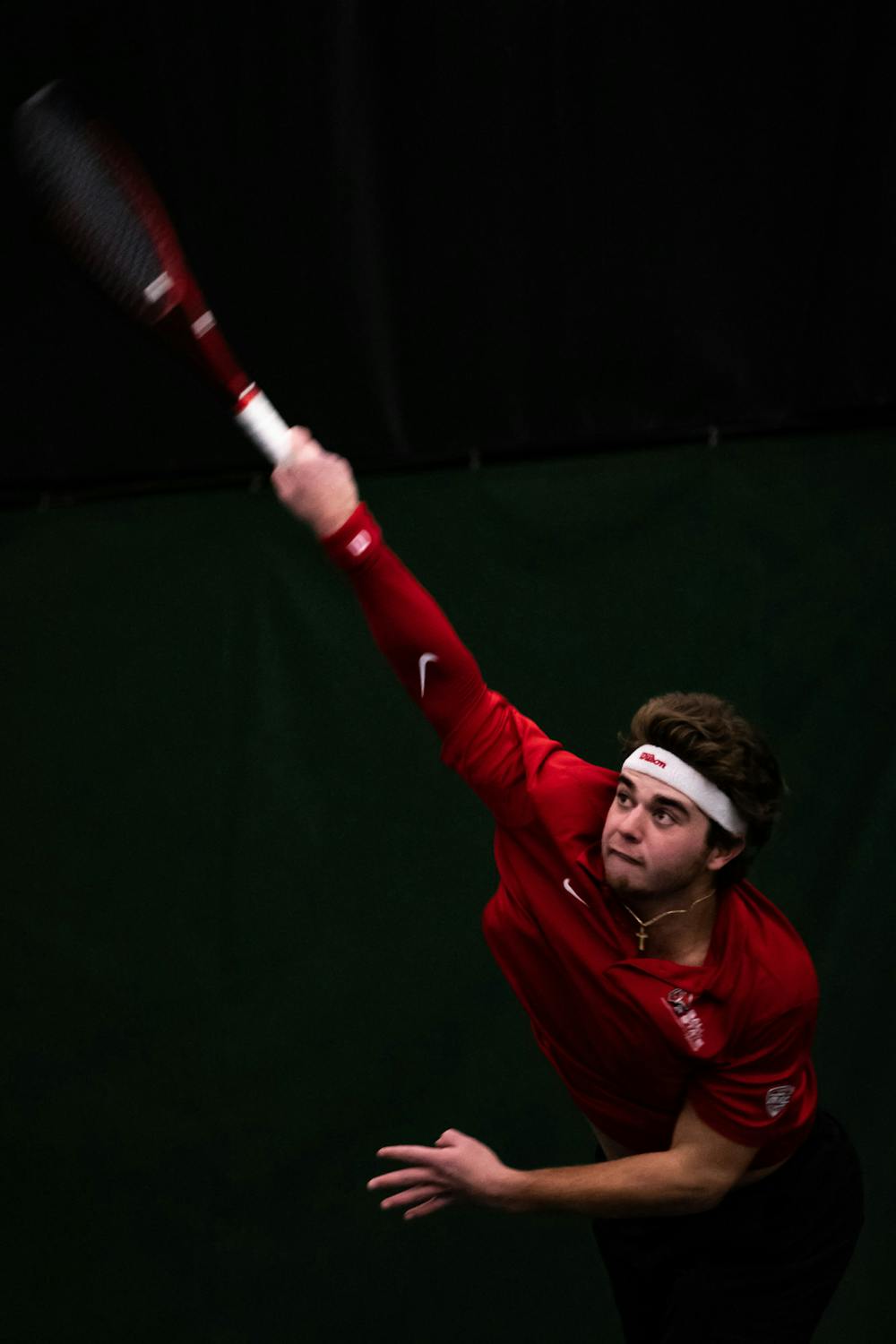 Senior Parrish Simmons returns the tennis ball to his opponent's side of the court in a Ball State vs. Eastern Illinois match, Jan. 20. The matchups began with doubles and ended with singles. Nathan Abbott, DN