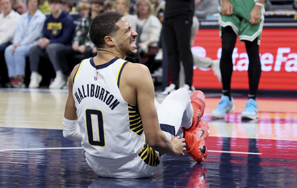 The Indiana Pacers' Tyrese Haliburton (0) grimaces after injuring his leg in the first half against the Boston Celtics at Gainbridge Fieldhouse on Jan. 8, 2024, in Indianapolis. (Andy Lyons/Getty Images/TNS)