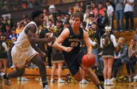 Senior Isaac Andrews dribbles the ball against Monroe Central Feb. 9 at Monroe Central High School. Andrew Berger, DN 