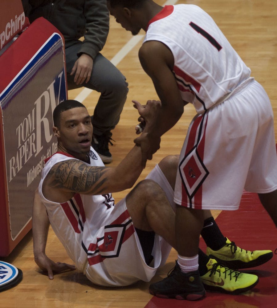 Helping guard Jeremiah Davis off of the floor, guard Zavier Turner uses both of his hands to pull Davis up. Ball State University played against Bowling Green on Saturday, Feb. 14. DN PHOTO Jason Conerly