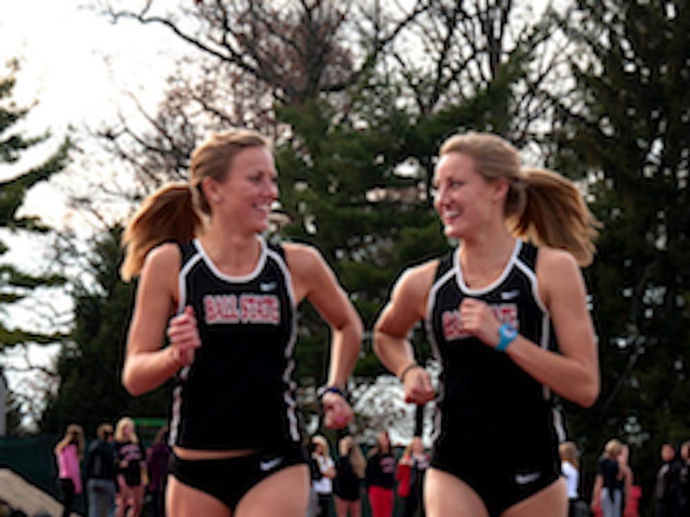 DN PHOTO RJ RICKER Twin Sisters, Caitlynn and Courtney Edon are members of the Ball State cross country team. Although only one of them qualified for regionals, both plan to be at the event. 