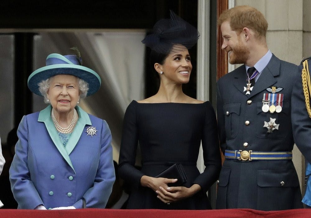 <p>In this July 10, 2018, file photo Britain's Queen Elizabeth II, Meghan, Duchess of Sussex, and Prince Harry watch a flypast of Royal Air Force aircraft pass over Buckingham Palace in London. As part of a surprise announcement distancing themselves from the British royal family, Harry and his wife Meghan declared they will “work to become financially independent." <strong>(AP Photo/Matt Dunham, File)</strong></p>