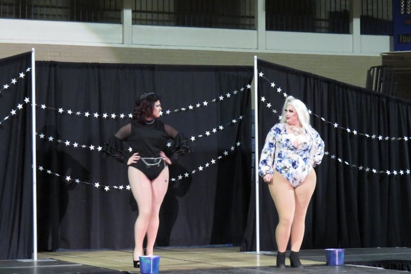 Two performers interact on stage during Spectrum's Gaylactic Drag Show April 6, 2019, at Ball Gym. Money raised at the drag show will benefit the National Center of Transgender Equality. Chase Martin, DN