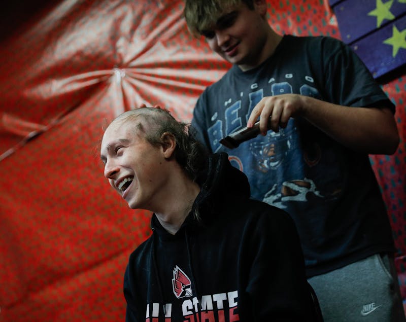 Ty Ransburg laughs as his head is shaved due to an Alopecia flare-up Dec. 2 at the Ball State Sigma Alpha Epsilon house. This is the second time that Ransburg has had to shave his hair. Andrew Berger, DN