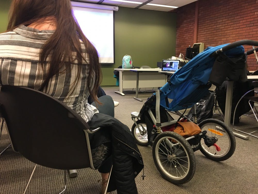 <p>Ball State students read testimonials on what it's like to be a parent.&nbsp;<em>Mary Freda // DN</em></p>