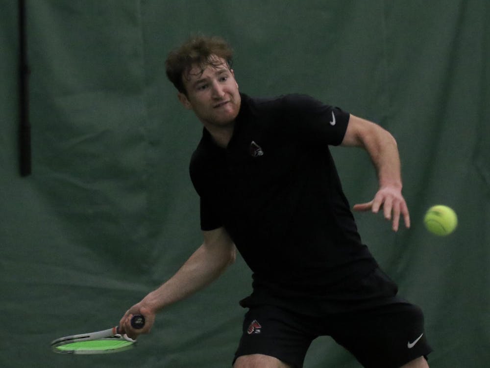 Junior Nathaniel Webster prepares to hit back the ball during a singles against Cleveland State University Feb. 10. at Muncie YMCA. Webster won both sets 5-4 and 7-6. Kate Tilbury, DN