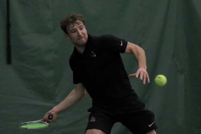 Junior Nathaniel Webster prepares to hit back the ball during a singles against Cleveland State University Feb. 10. at Muncie YMCA. Webster won both sets 5-4 and 7-6. Kate Tilbury, DN