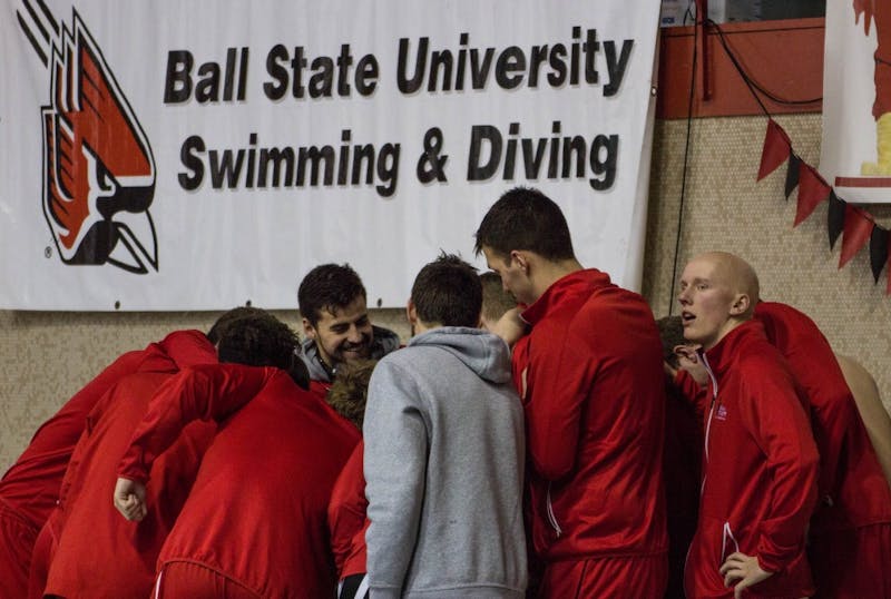 The Ball State men's swimming and diving team huddle before the senior meet against Notre Dame on Feb. 4 in Lewellen Pool. The Cardinals lost 82.5-148.5. Grace Ramey // DN