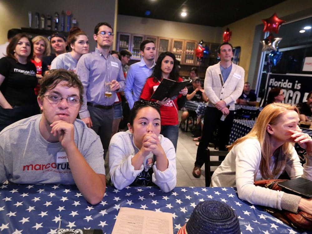 Marco Rubio supporters react with shock at a watch party in Orlando, Fla., as the GOP presidential contender announces the suspension of his campaign on Tuesday, March 15, 2016. (Joe Burbank/Orlando Sentinel/TNS)