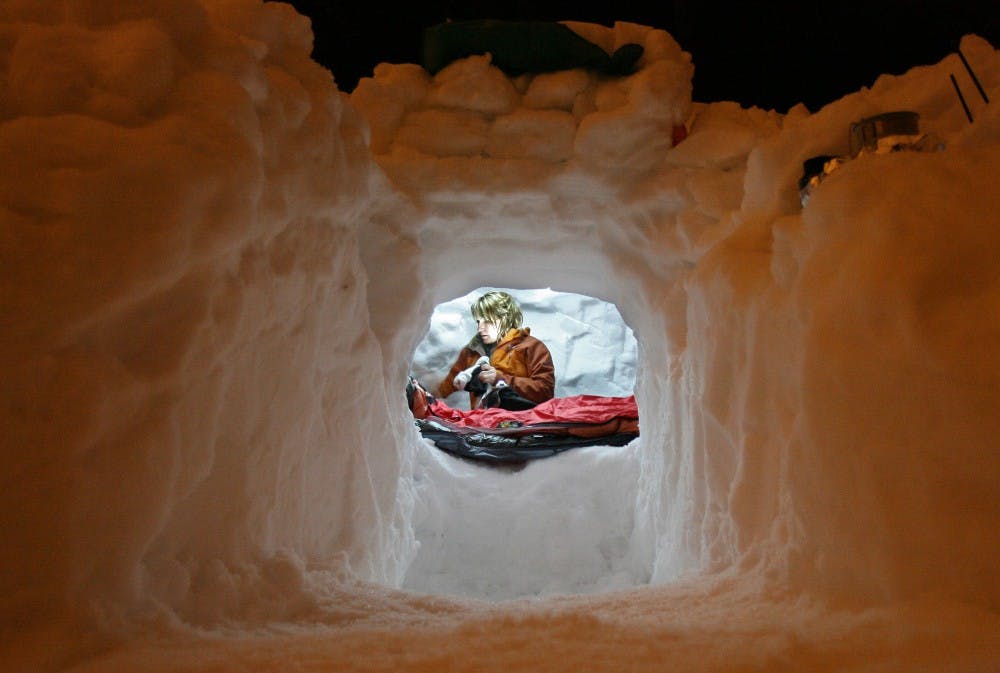 Christina Fritzinger, of Tacoma, hunkers down inside a snow cave she constructed on Snoqualmie Pass, Washington, February 3, 2007, as part of a weekend snow survival course offered by The Mountaineers. (Steve Ringman/Seattle Times/MCT)