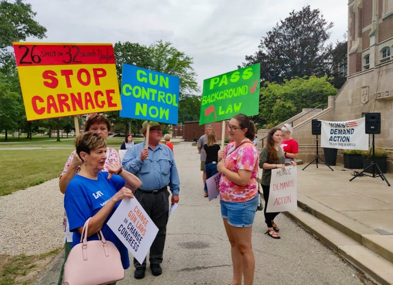 People gather with their signs before the rally Aug. 17, 2019, near the steps of the David Owsley Museum of Art in the Quad. The rally was organized by Moms Demand Action and Students Demand Action, two organizations campaigning against gun violence. Rohith Rao, DN