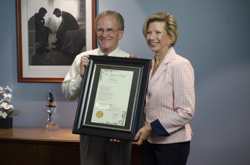 Mayor Dennis Tyler and President Jo Ann Gora pose for a photo after Tyler gave her the Spirit of Chief Munsee award June 6 at the mayor's office in Muncie City Hall. Gora will retire from Ball State at the end of June. DN PHOTO BREANNA DAUGHERTY