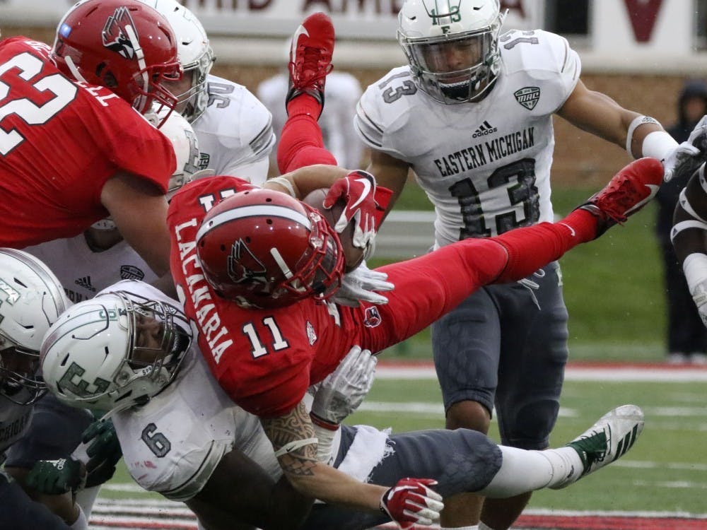Ball State redshirt senior wide receiver Corey Lacanaria gets tackled by Eastern Michigan University's Jaylen Pickett during the Cardinals' game against the Eagles Oct. 20, 2018 at Scheumann Stadium. Pickett had two solo tackles. Paige Grider, DN