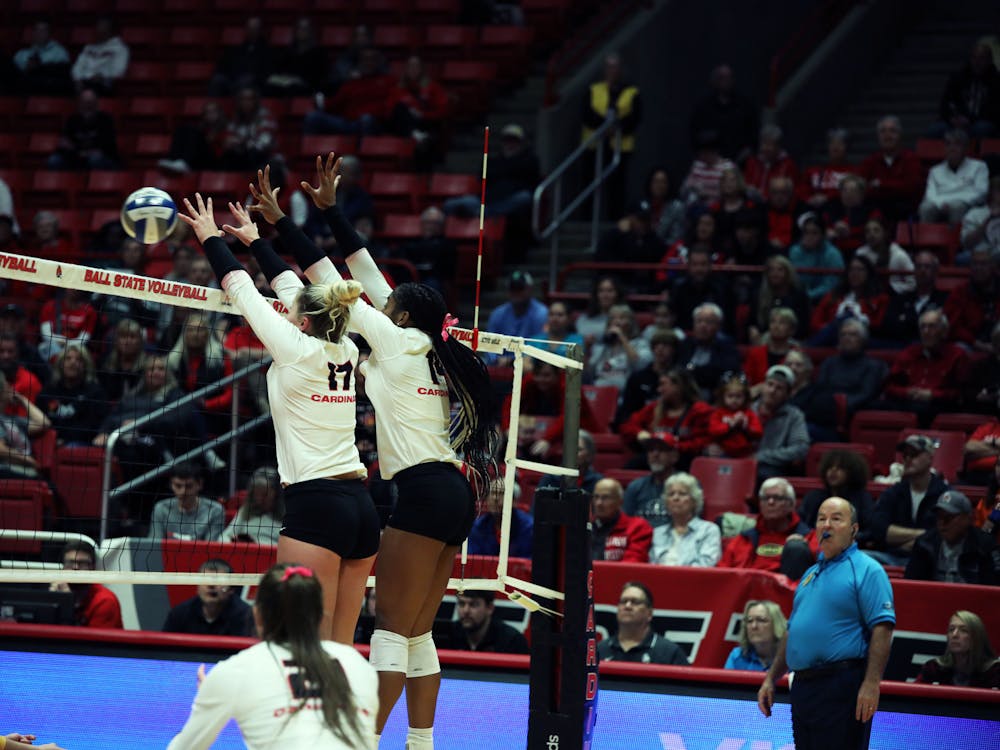 Freshman middle blocker Camryn Wise (left) and redshirt freshman middle blocker Aniya Kennedy (right) block the ball against Toledo Oct. 17 at Worthen Arena. Mya Cataline, DN