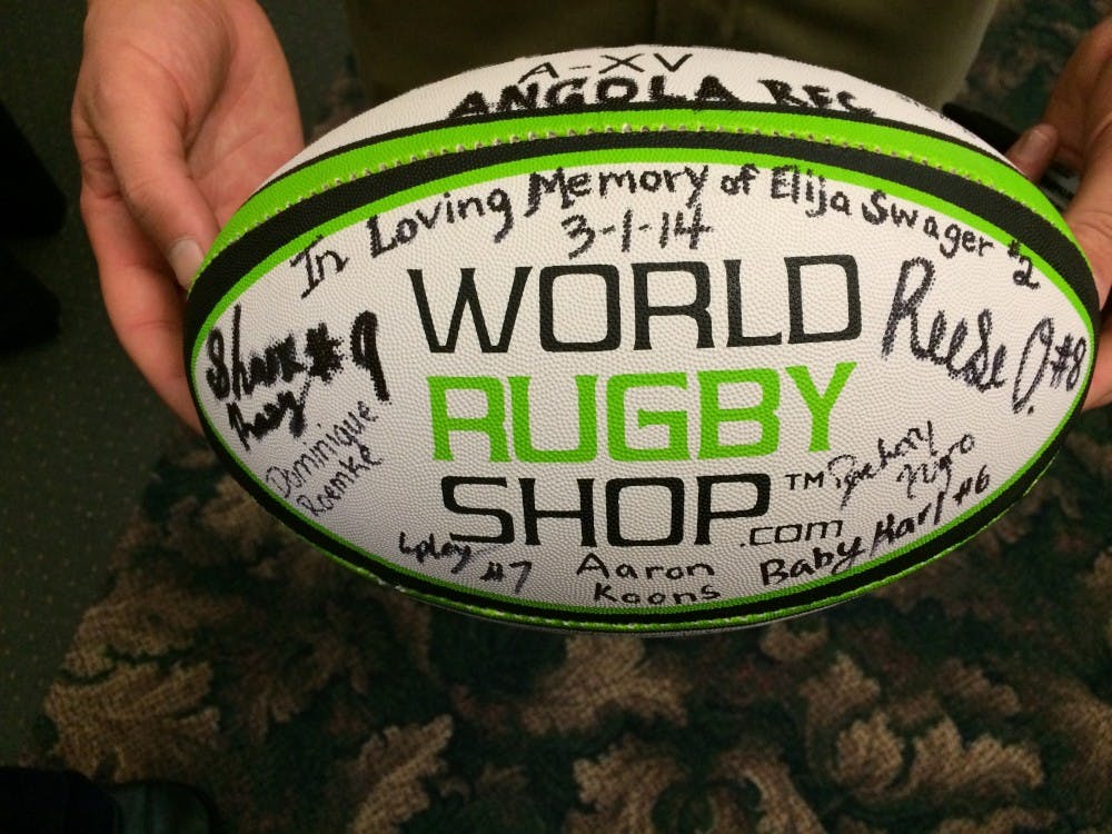 	Reese Oberlin, a close friend of Elija Swager, holds a ball that Angola High School&#8217;s rugby team signed in honor of Swager. Swager, a Ball State freshman, died in an apartment complex off campus March 1. His funeral was March 6 in his hometown of Angola, Ind.