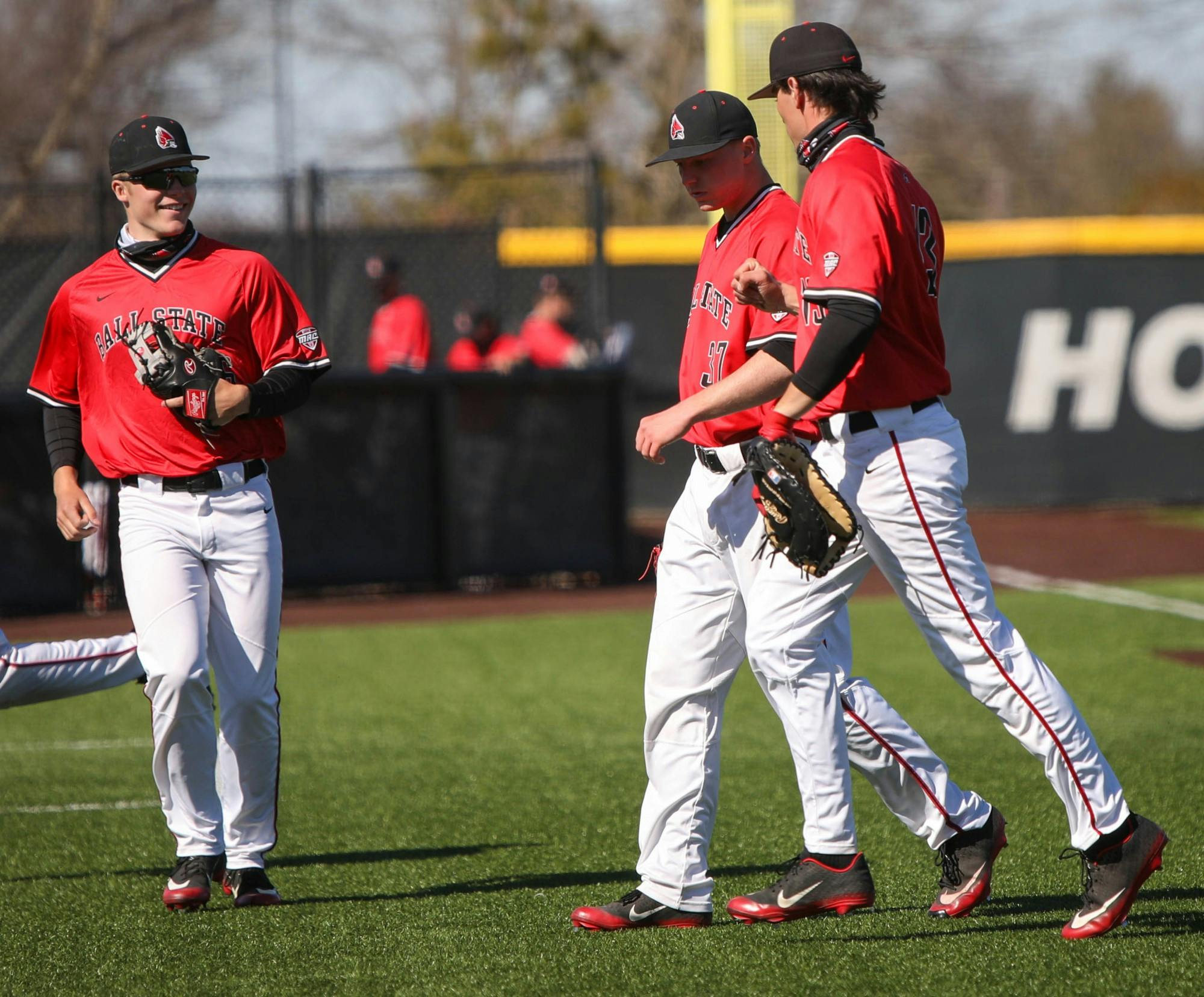 Freshman infielder Zach Lane, senior left-handed pitcher Lukas Jaksich and junior first baseman Trenton Quartermaine celebrate after an inning March 20, 2021, at First Merchants Ballpark. The Cardinals won their second game of the day 3-2 against Western Michigan. Jaden Whiteman, DN