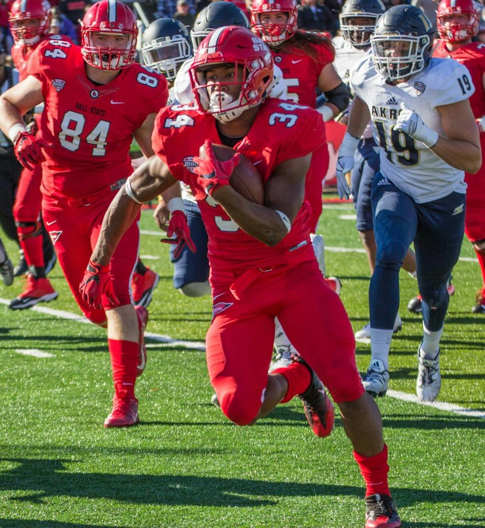 <p>Ball State's running back James Gilbert attempts to run the ball down the field in the game against Akron on Oct. 22 in Scheumann Stadium. The Cardinals lost 25 to 35. <em>Grace Ramey // DN</em></p>