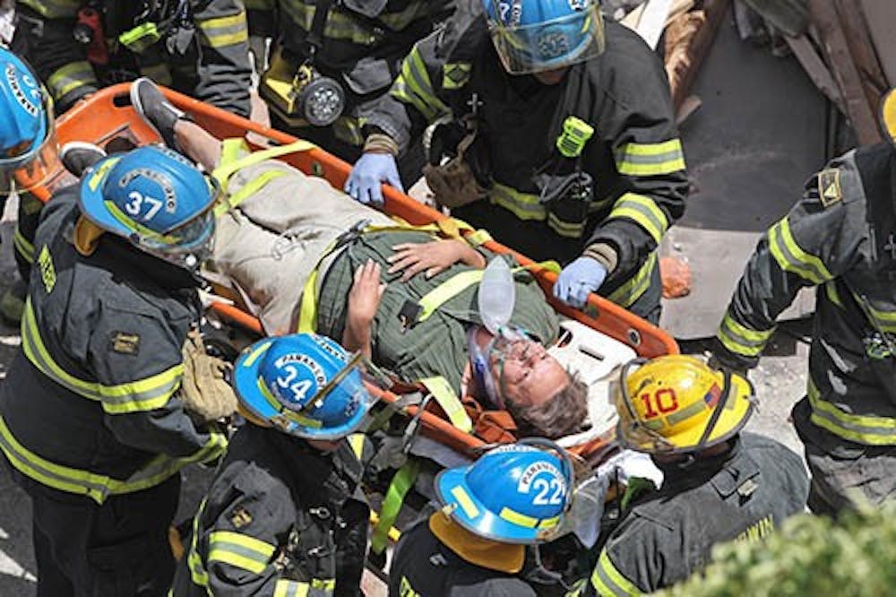 Philadelphia firefighters carry a survivor from the rubble of a collapsed building at 22nd and Market streets in Philadelphia, Pa., on Wednesday. MCT PHOTO