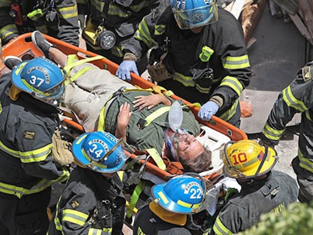 Philadelphia firefighters carry a survivor from the rubble of a collapsed building at 22nd and Market streets in Philadelphia, Pa., on Wednesday. MCT PHOTO