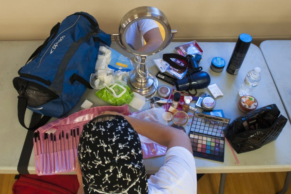 Makeup pallets and rolls of brushes fill sections of tables designated for each of the performers. Each was allowed half a table that lined the perimeter of the room. They were asked to keep to their half of the table to be considerate to special guests who had little time to get ready before taking the stage at Ball State.