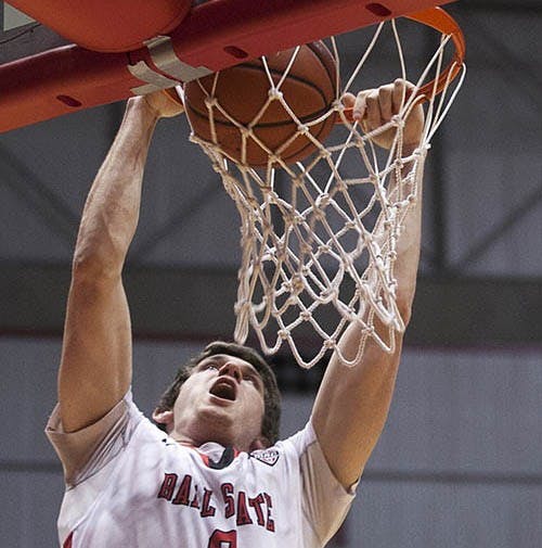 Junior Matt Kamieniecki completes a dunk during the game against Eastern Michigan Saturday. Kamieniecki injured his back during the game. DN PHOTO JORDAN HUFFER