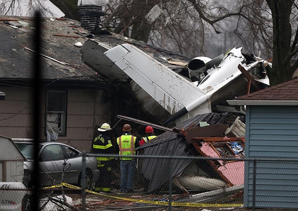 South Bend firefighters look over the wreckage of a small jet on Monday, March 18, 2013, that crashed Sunday near the South Bend Airport in South Bend, Indiana. (Scott Strazzante/Chicago Tribune/MCT)