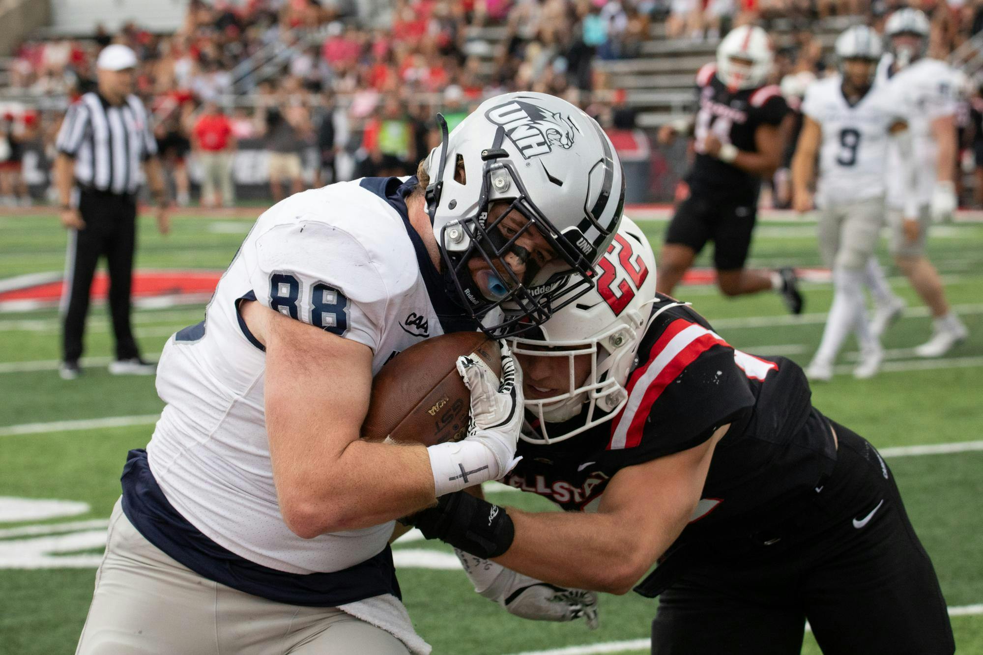 New Hampshire junior tight end Drew Danson is hit by Ball State senior linebacker Jack Beebe Sept. 13 at Scheumann Stadium. Beebe had four solo tackles in the game. Andrew Berger, DN 