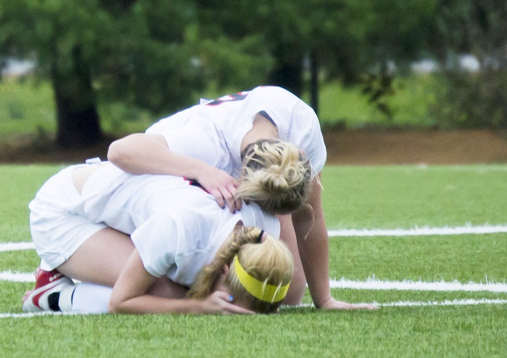 Players comfort each other losing to Northern Illinois University 1-1 (4-3) on Oct. 30 at Briner Sports Complex. Teri Lightning Jr., DN