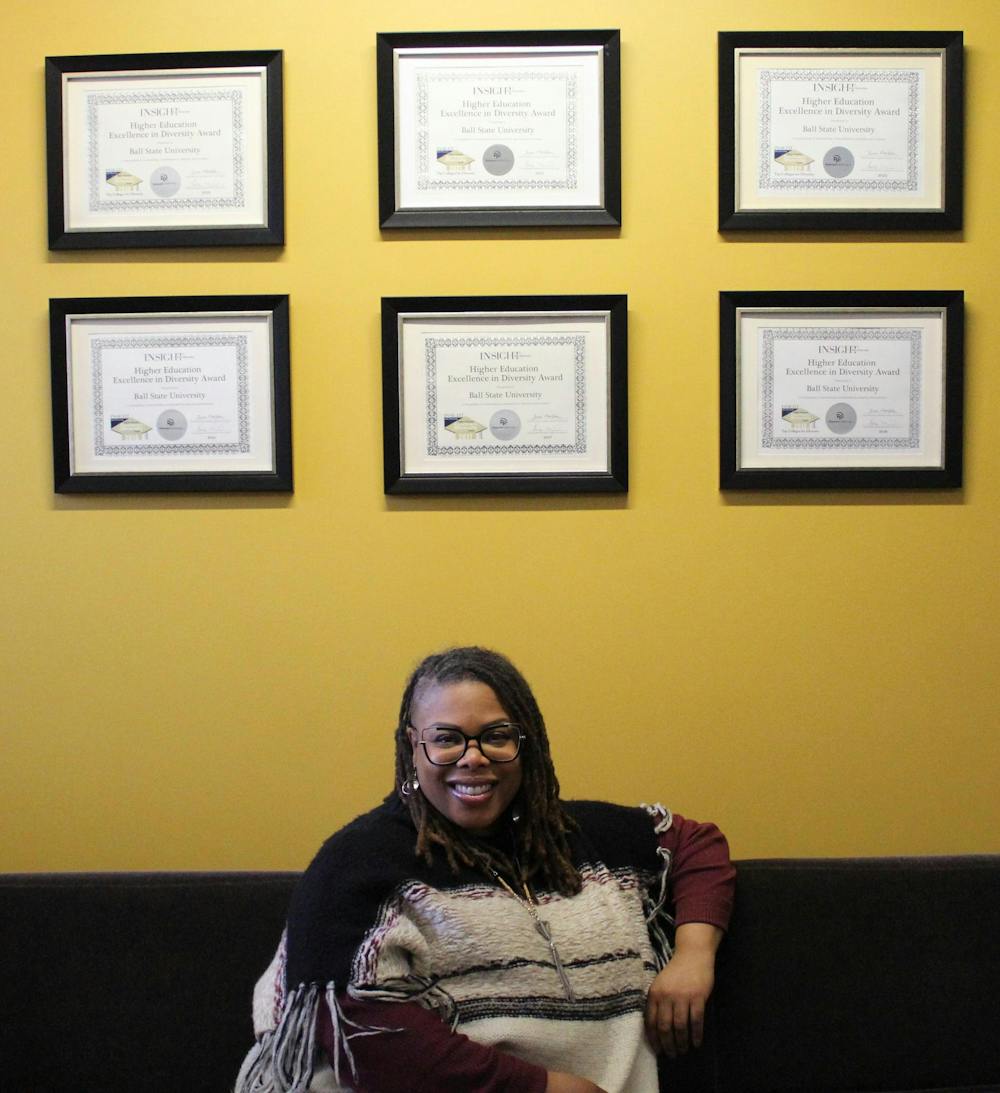 Associate vice president of inclusive excellence Rashida Willard poses in front of previous HEED Awards Nov. 15 in the Office of Inclusive Excellence at the Applied Technology Building. Meghan Braddy, DN
