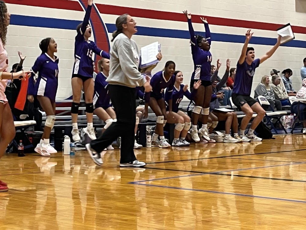 Muncie Central bench celebrates as Lady Bearcats get their first win in the invitational. The team lost six previous matches during the day. Photo by Evan Shotts.